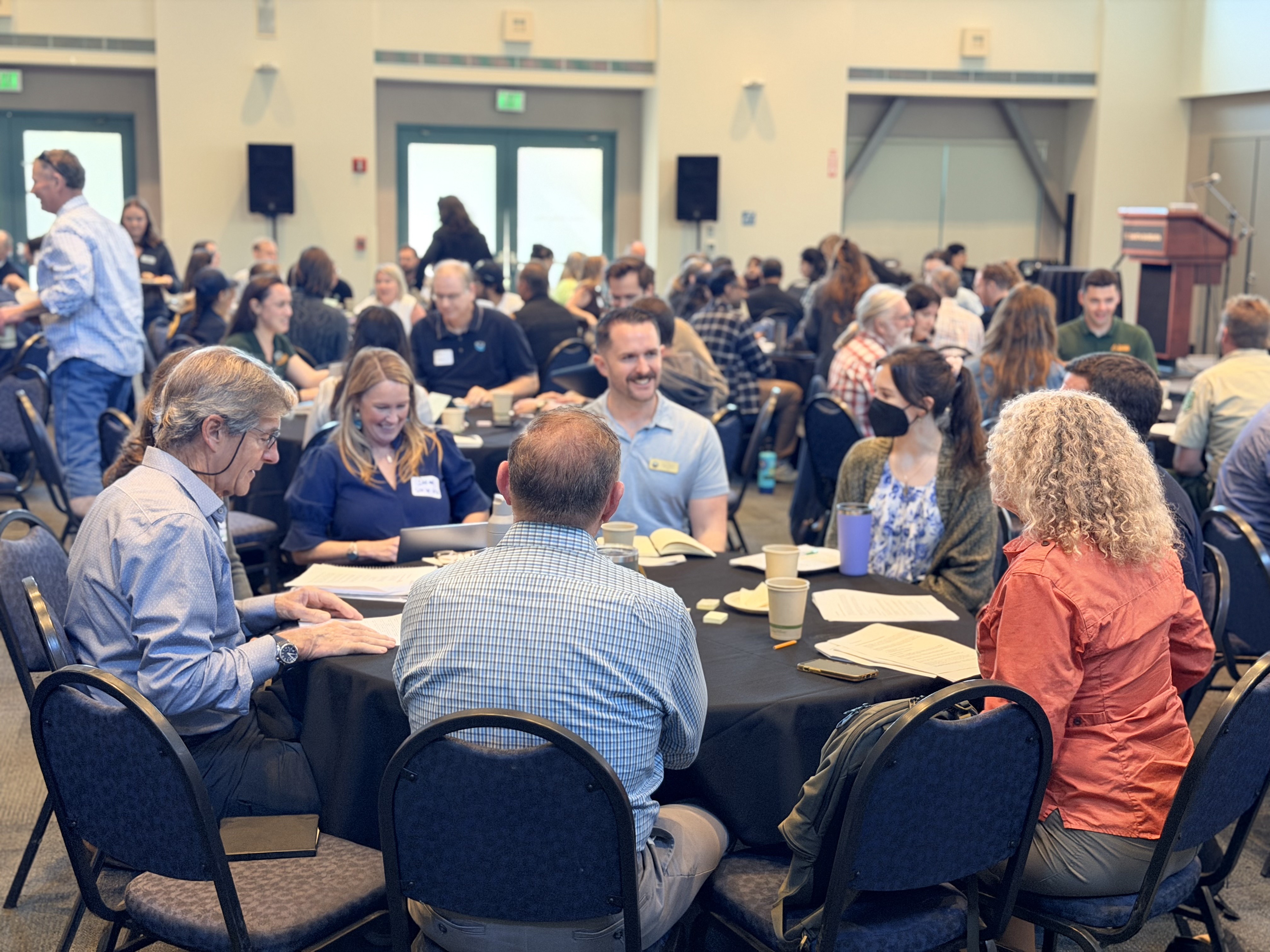 Participants sit around tables during the inaugural meeting of the Santa Barbara Wildfire Resilience Collaborative at Corwin Pavilion.
