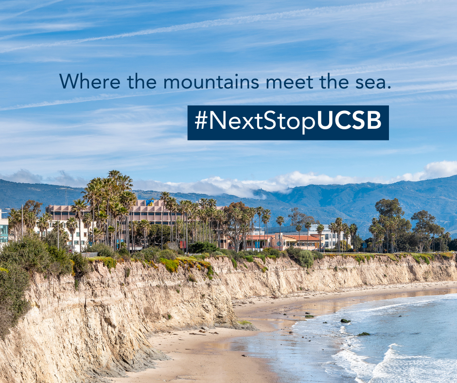 A wide-angle landscape photograph of the University of California, Santa Barbara campus. The foreground shows a sandy beach and the Pacific Ocean. Above the beach, light-colored sedimentary bluffs support lush green vegetation and several campus buildings, including a large multi-story research facility with palm trees lining the cliffside. In the far distance, the blue-toned Santa Ynez Mountains are visible under a bright blue sky with wispy cirrus clouds. Overlaid on the upper third of the image is the da