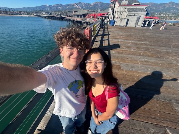 Andrew Tolu smiling with a friend on the Goleta Pier.