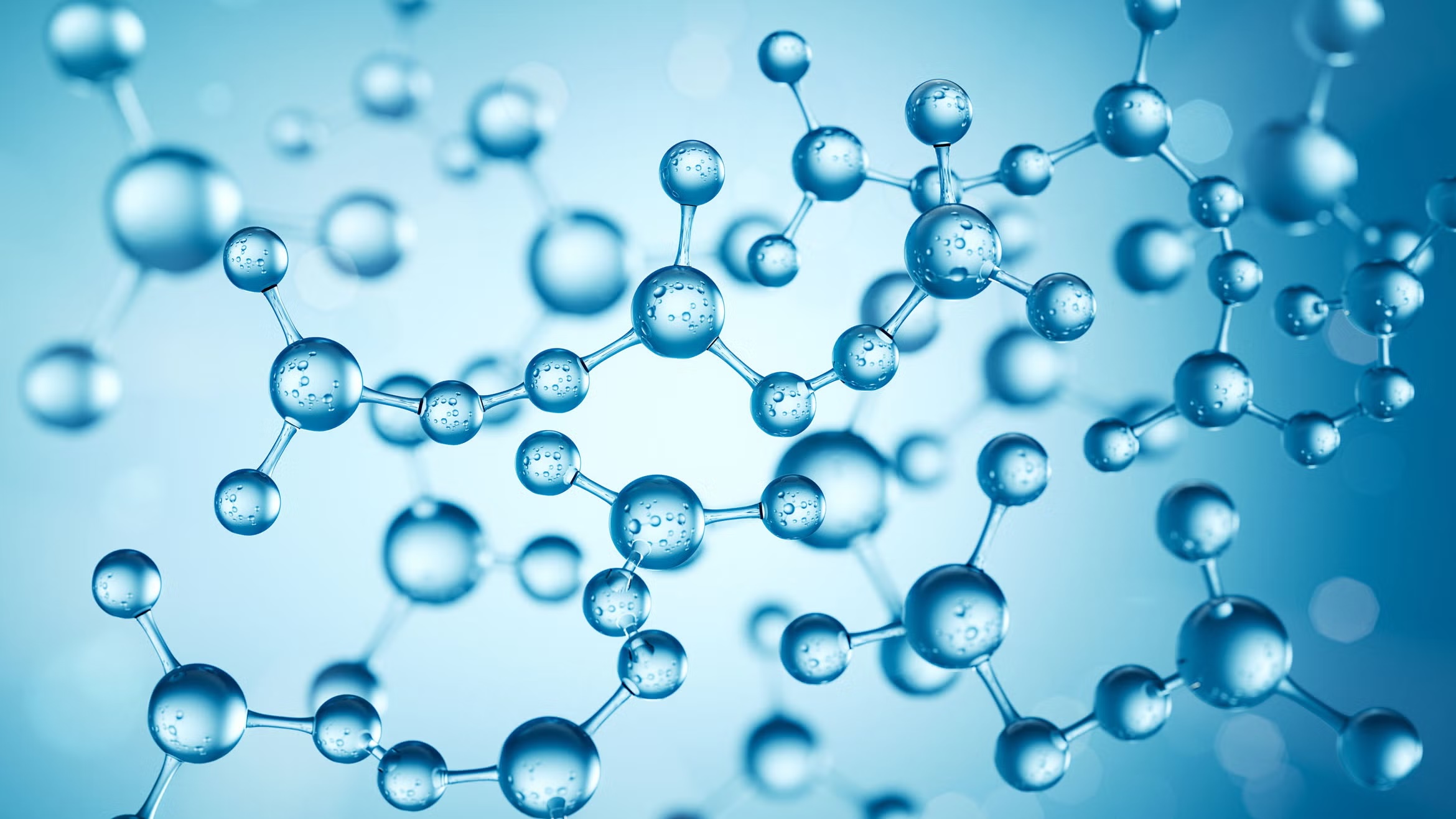 Abstract scientific illustration of blue spherical molecules connected by bonds, floating against a light blue, soft-focus background.