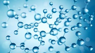 Abstract scientific illustration of blue spherical molecules connected by bonds, floating against a light blue, soft-focus background.