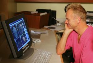   Sting looks at his brain scans at McGill University’s Montreal Neurological Institute. Photo Credit: OWEN EGAN
