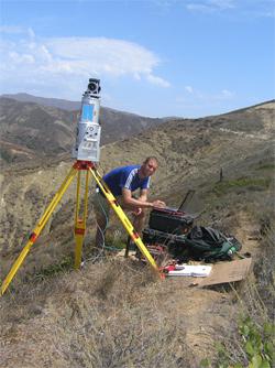 Bodo Bookhagen working with a lidar device that his group uses for detecting changes in the landscape, including on snow fields and glaciers.